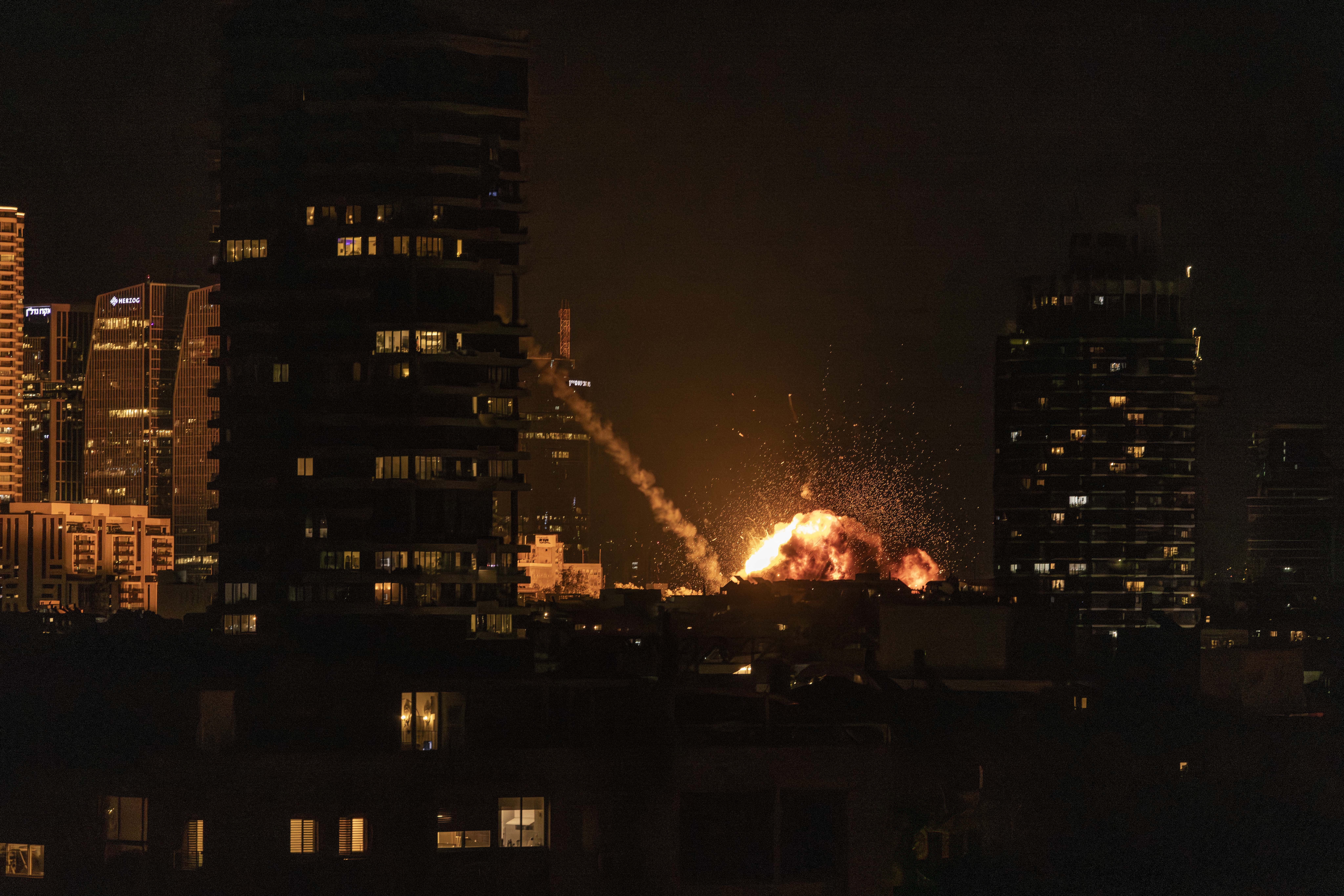 A fireball lights the sky following a missile strike on Tel Aviv on February 28, 2026. The United States and Israel launched strikes against Iran on February 28, with Israel's public broadcaster reporting that the Iranian supreme leader had been targeted, as the Islamic republic retaliated with barrages of missiles at Gulf states and Israel. (Photo by JOHN WESSELS / AFP)